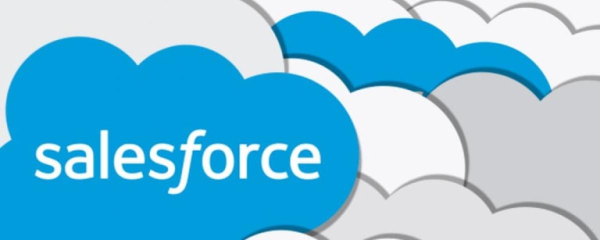 Salesforce logo, a blue cloud with white type, in front of multiple clouds overlapping in the background