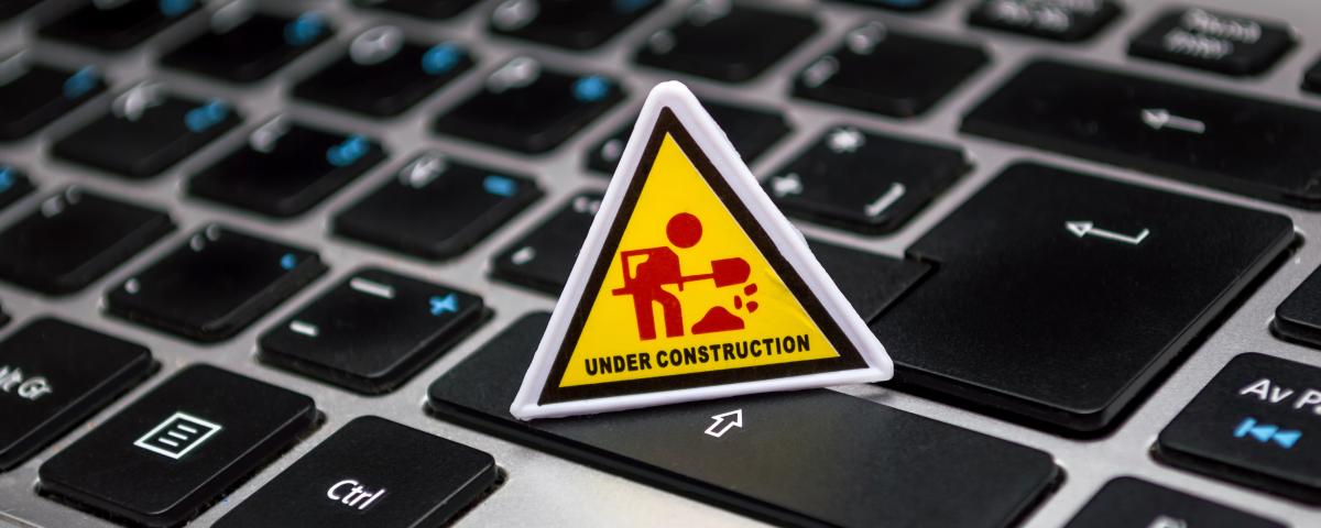 A computer keyboard with an Under Construction sign on it