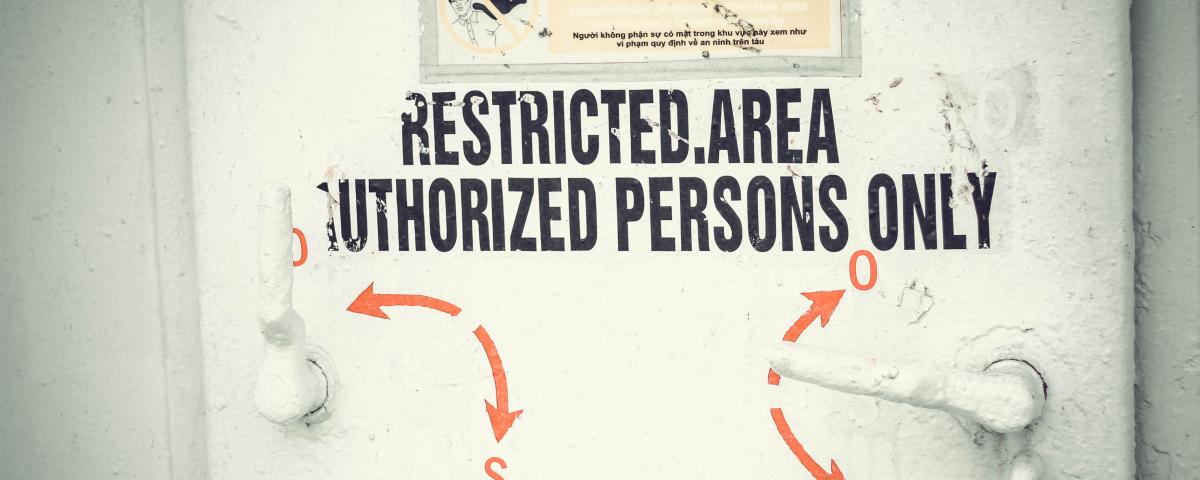 Image of a door with a sign reading: Restricted area, Authorized Persons Only