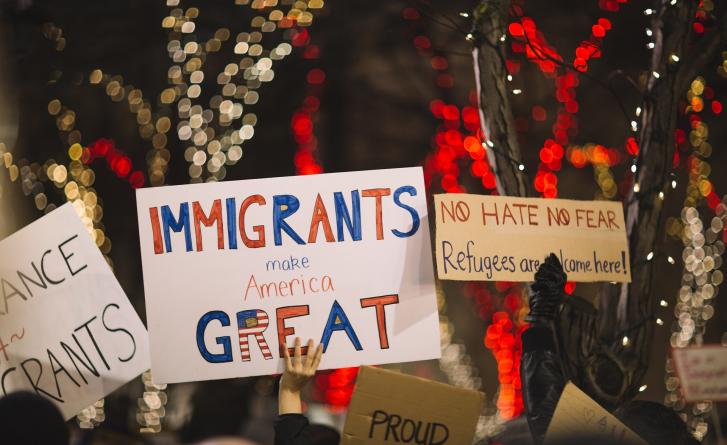 A poster that reads "Immigrants make America great." 